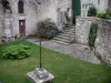 Yèvre-le-Châtel - Saint-Gault church, cross, lawn, stair and stone house